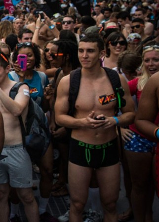 NEW YORK, NY - AUGUST 05: A man wearing only his underwear dances in front of a crowd in Times Square in an attempt to break the Guinness Book of World Records' record for "the most amount of people gathered in their underwear in the Times Square section of New York" on August 5, 2013 in New York City. Organizers were hoping to get 2,271 people to strip down to their underwear - the current record is 2,270. (Photo by Andrew Burton/Getty Images)