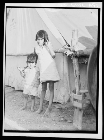 Niños migrantes mexicanos en el campamento del contratista en el momento de la cosecha de guisantes temprana. Nipomo, California