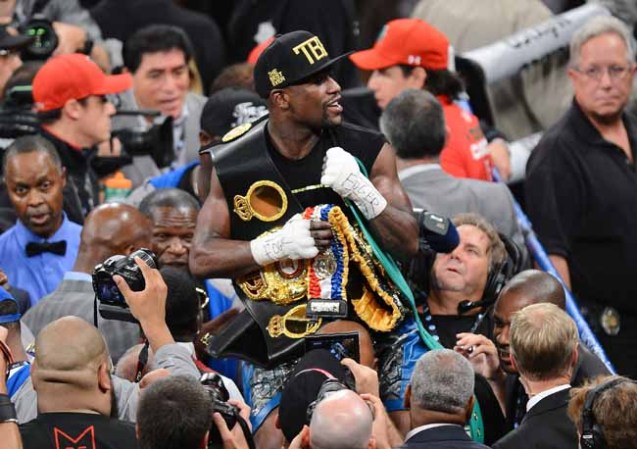 LAS VEGAS, NV - SEPTEMBER 14: Floyd Mayweather Jr. celebrates his majority-decision victory over Canelo Alvarez in their WBC/WBA 154-pound title fight at the MGM Grand Garden Arena on September 14, 2013 in Las Vegas, Nevada. (Photo by Ethan Miller/Getty Images)