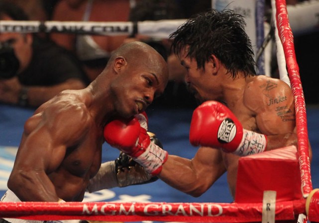 LAS VEGAS, NV - JUNE 09: (R-L) Manny Pacquiao lands a right to the head of Timothy Bradley during their WBO welterweight title fight at MGM Grand Garden Arena on June 9, 2012 in Las Vegas, Nevada. (Photo by Jeff Bottari/Getty Images)