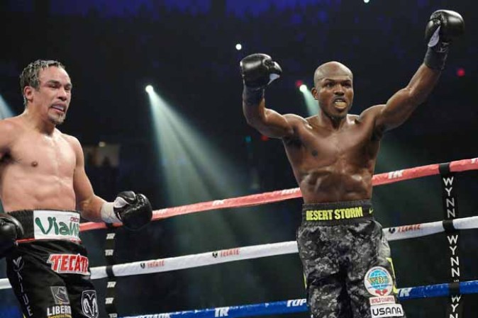 LAS VEGAS, NV - OCTOBER 12: WBO welterweight champion Timothy Bradley Jr. (R) celebrates after going twelve rounds with Juan Manuel Marquez during their bout at the Thomas & Mack Center on October 12, 2013 in Las Vegas, Nevada. Timothy Bradley Jr. wins in a split-decision victory over Juan Manuel Marquez. (Photo by Jeff Bottari/Getty Images)