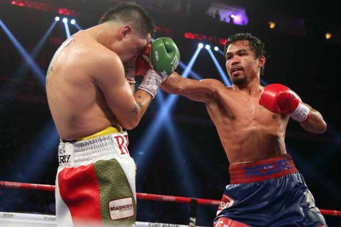 MACAU - NOVEMBER 24: Manny Pacquiao (R) of the Philippines fights with Brandon Rios of the U.S. during their 'Clash in Cotai' WBO International Welterweight title bout on November 24, 2013 in Macau. (Photo by Nicky Loh/Getty Images)