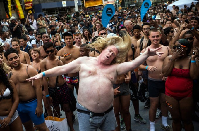 NEW YORK, NY - AUGUST 05: A man wearing only his underwear dances in front of a crowd in Times Square in an attempt to break the Guinness Book of World Records' record for "the most amount of people gathered in their underwear in the Times Square section of New York" on August 5, 2013 in New York City. Organizers were hoping to get 2,271 people to strip down to their underwear - the current record is 2,270. (Photo by Andrew Burton/Getty Images)