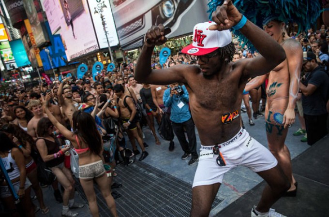 NEW YORK, NY - AUGUST 05: A man wearing only his underwear dances in front of a crowd in Times Square in an attempt to break the Guinness Book of World Records' record for "the most amount of people gathered in their underwear in the Times Square section of New York" on August 5, 2013 in New York City. Organizers were hoping to get 2,271 people to strip down to their underwear - the current record is 2,270. (Photo by Andrew Burton/Getty Images)
