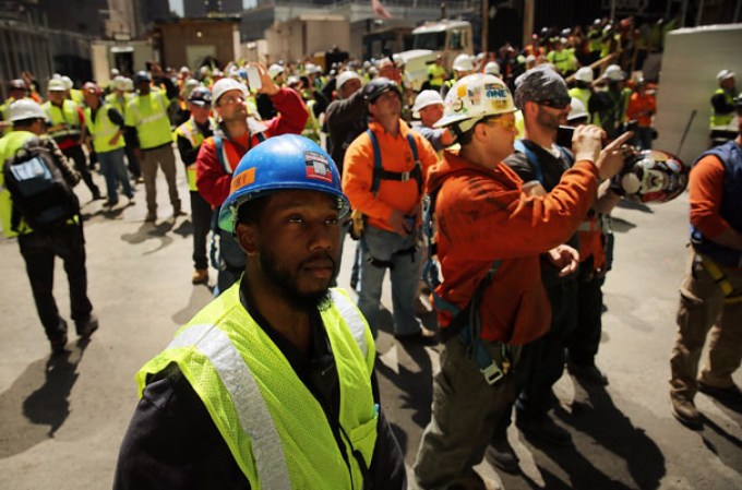 NEW YORK, NY - MAY 02: Construction workers watch as the 408-foot spire is hoisted onto a temporary platform on the top of One World Trade Center on May 2, 2013 in New York City. When bolted into place at a later date, the spire will make One World Trade Center the tallest building in the Western Hemisphere.The raising of the spire, which comes on the second anniversary of the death of Osama bin Laden, will make One World Trade Center 1,776 feet tall. One World Trade Center is built on the site where the September 11, 2001 attacks toppled the original World Trade Center towers. (Photo by Spencer Platt/Getty Images)