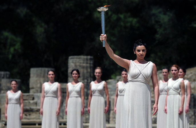 ATHENS, GREECE - MAY 10: High Priestess Ino Menegaki lights the Olympic flame at the Temple of Hera during the Lighting Ceremony of the Olympic Flame at Ancient Olympia on May 10, 2012 in Olympia, Greece. (Photo by Jamie McDonald/Getty Images)