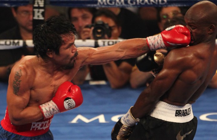 LAS VEGAS, NV - JUNE 09: (L-R) Manny Pacquiao lands a left to the head of Timothy Bradley during their WBO welterweight title fight at MGM Grand Garden Arena on June 9, 2012 in Las Vegas, Nevada. (Photo by Jeff Bottari/Getty Images)