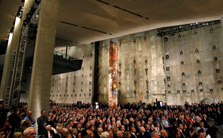 NEW YORK, NY - MAY 15: Invited guests listen as U.S. President Barack Obama speaks during the opening ceremony for the National September 11 Memorial Museum at ground zero May 15, 2014 in New York City. The museum spans seven stories, mostly underground, and contains artifacts from the attack on the World Trade Center Towers on September 11, 2001 that include the 80 ft high tridents, the so-called "Ground Zero Cross," the destroyed remains of Company 21's New York Fire Department Engine as well as smaller items such as letter that fell from a hijacked plane and posters of missing loved ones projected onto the wall of the museum. The museum will open to the public on May 21. (Photo by Mike Segar-Pool/Getty Images)