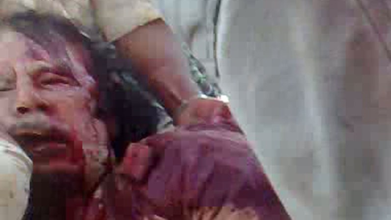 CORRECTING BYLINE<br />A grab from a video taken from the mobile phone of a National Transitional Council (NTC) fighter shows the arrest of Libya's strongman Moamer Kadhafi in Sirte on October 20, 2011. AFP PHOTO/DSK (Photo credit should read PHILIPPE DESMAZES/AFP/Getty Images)