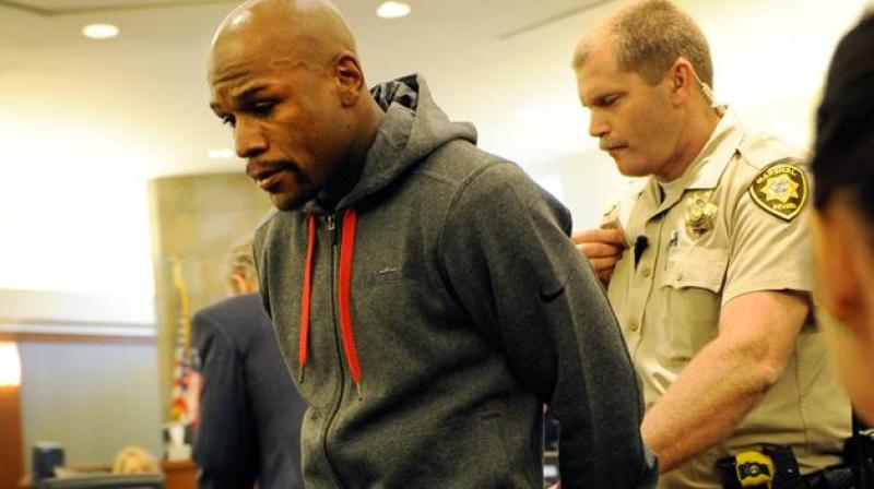 LAS VEGAS, NV - JUNE 01: Boxer Floyd Maywether Jr. is lead away in handcuffs at the Clark County Regional Justice Center as he surrenders to serve a three-month jail sentence at theÊClark County Detention CenterÊon June 1, 2012 in Las Vegas, Nevada. ÊMayweather pleaded guilty in December to attacking his ex-girlfriend while two of their children watched in September 2010. (Photo by David Becker/Getty Images)