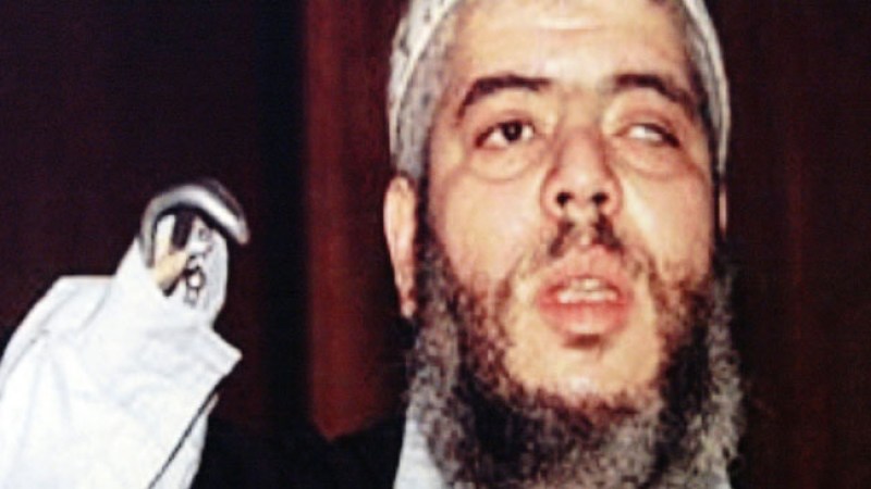 NEW YORK - MAY 27: A picture of terror suspect Mustafa Kamel Mustafa, a/k/a Abu Hamza, is seen during an announcement of his arrest by U.S. Attorney General John Ashcroft May 27, 2004 in New York City. Mustafa, the former iman at the Finsbury Park mosque in London, is being sought by U.S. authorities for extradition in connection with an attack in Yemen in December 1998 that resulted in the death of four hostages. The former iman was arrested May 27 on an U.S. extradition warrant. (Photo by Spencer Platt/Getty Images)