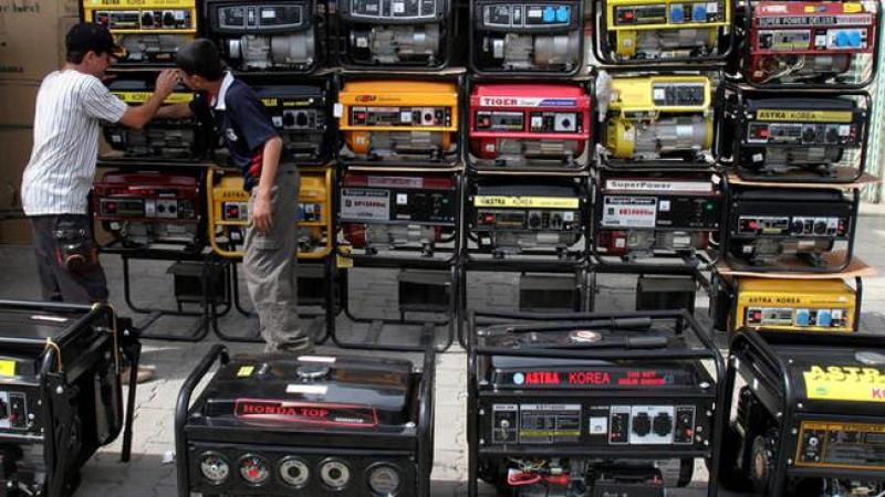 ** FOR WEEKEND EDITIONS, APRIL 7-8 ** Iraqi youths inspect generators for sale in central Baghdad, Iraq, Saturday, March 31, 2007. In Baghdad since the US led invasion in 2003, gone missing are the simple things that feed body and soul: drinkable water that flows from a tap, electricity that stays on, movie theaters that open, booksellers with new books. (AP Photo/Samir Mizban)