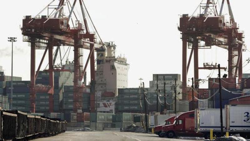 A container ship is loaded at Port Newark in Newark, N.J., Tuesday, Feb. 21, 2006. President Bush said Tuesday that a deal allowing an Arab company to take over six major U.S. seaports should go forward and that he would veto any congressional effort to stop it. (AP Photo/Mike Derer)