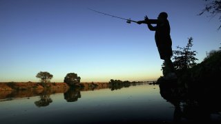 A fisherman casts his line into the Sacramento River.