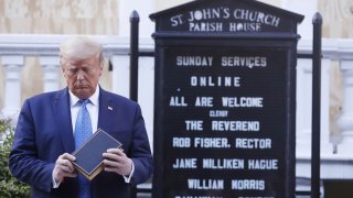 President Donald Trump looks at his Bible in front of St. John's Church.