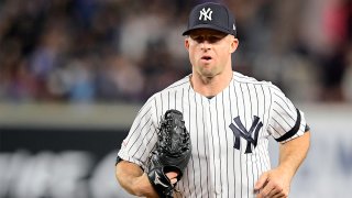 Yankees player Brett Garnder in a pinstripe Yankee uniform and hat wearing a baseball glove