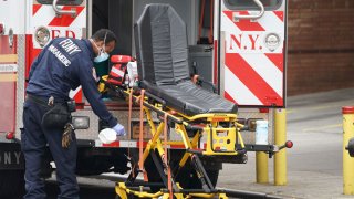 An FDNY paramedic disinfects the ambulance equipment after bringing a patient to Wyckoff Hospital in the Bushwick section of Brooklyn April 5, 2020 in New York