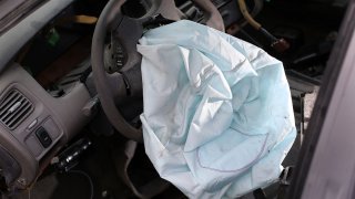A deployed airbag is seen in a 2001 Honda Accord