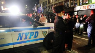 Groups of protesters gather in the Brooklyn neighborhood of Borough Park to denounce lockdowns of their neighborhood