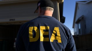 In this Jan. 31, 2019, file photo, a DEA agent is seen in Commerce City, Colorado.