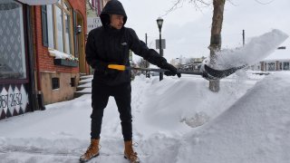 Person throwing a shovel-full of snow