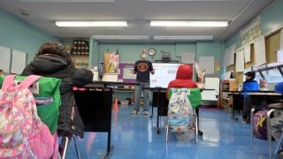 A view of a teacher and students at Yung Wing School P.S. 124