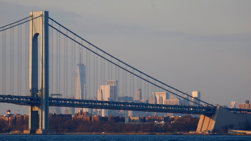 The Verrazzano-Narrows Bridge sits in front of One World Trade Center