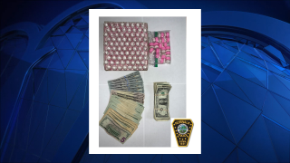 Police photo of seized cash and guns