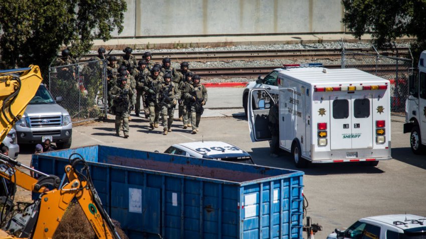 SAN JOSE, CA – MAY 26: Tactical law enforcement officers move through the Valley Transportation Authority (VTA) light-rail yard where a mass shooting occurred on May 26, 2021 in San Jose, California. A VTA employee opened fire at the yard, with preliminary reports indicating nine people dead including the gunman. (Photo by Philip Pacheco/Getty Images)