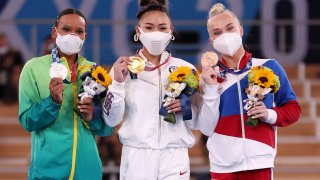 From left: Silver medalist Rebeca Andrade of Team Brazil, gold medalist Sunisa Lee of Team USA and bronze medalist Angelina Melnikova of Team ROC pose for a photo after the Women's All-Around Final on day six of the Tokyo 2020 Olympic Games at Ariake Gymnastics Centre on July 29, 2021 in Tokyo, Japan.