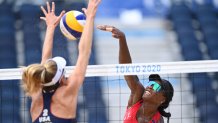 USA's Alix Klineman (L) blocks a shot by Cuba's Leila Consuelo Martinez Ortega in their women's beach volleyball round of 16 match between Cuba and the USA during the Tokyo 2020 Olympic Games at Shiokaze Park in Tokyo on Aug. 2, 2021.