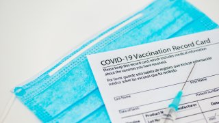Syringe with vaccine and vaccination certificate
