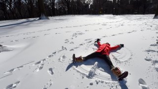 Tara Jakeway with Chasing News makes a snow angel in the man-made snow