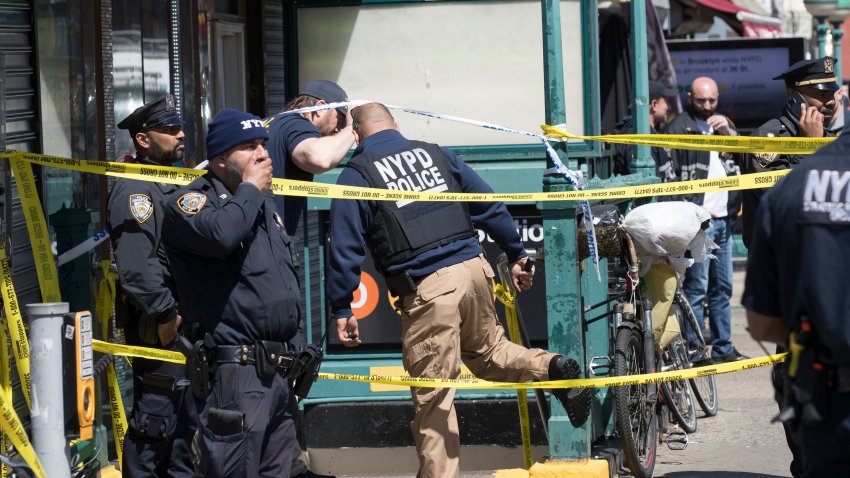 NEW YORK, NEW YORK – APRIL 12: Police and investigators work at the scene of a shooting at the 36th Street subway station on April 12, 2022 in the Brooklyn borough of New York City. (Photo by Liao Pan/China News Service via Getty Images)