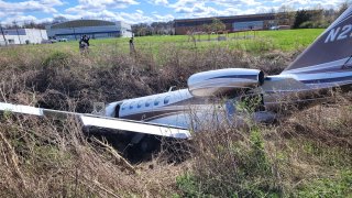 Plane stuck in brook at Essex County Airport