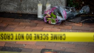 Flowers are laid near the scene of a shooting at a Fourth of July parade on July 5, 2022, in Highland Park, Illinois.