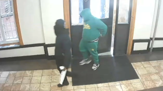 Two suspects entering building accused of impersonating police.