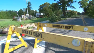 Yellow signs restrict access to a Mattituck road where trees where knocked down.