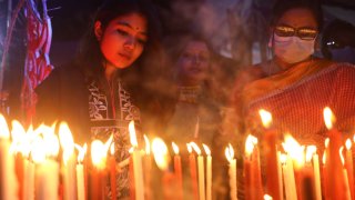Devotees light up candles as part of Diwali celebration
