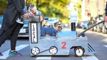Dianne Ferrer and Tim Lawson wheel french bulldogs, Carly and Max all dressed as a train and the conductors. (Photo by Alexi Rosenfeld/Getty Images)