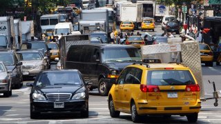 Cars, taxis and trucks sit in traffic in midtown Manhattan. (Photo credit: TIMOTHY A. CLARY/AFP via Getty Images)