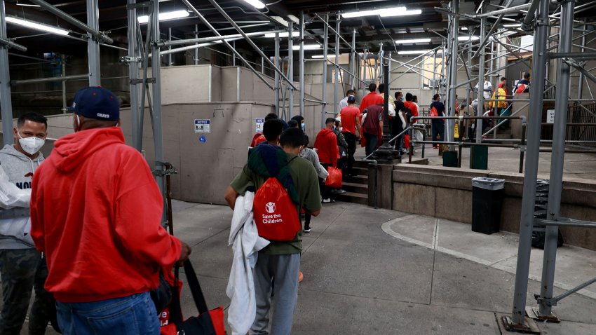 Around 60 recently arrived Venezuelan migrants are seen entering a shelter at Bellevue early Wednesday morning, Oct. 12, 2022, in Manhattan, New York. (Luiz C. Ribeiro/New York Daily News/Tribune News Service via Getty Images)