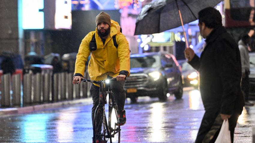 NEW YORK, NY – DECEMBER 15: People walk through the rain and sleet in Manhattan as temperatures begin to fall on December 15, 2022 in New York City. A winter storm moving into the area could make for messy Friday morning commutes. (Photo by Fatih Aktas/Anadolu Agency via Getty Images)