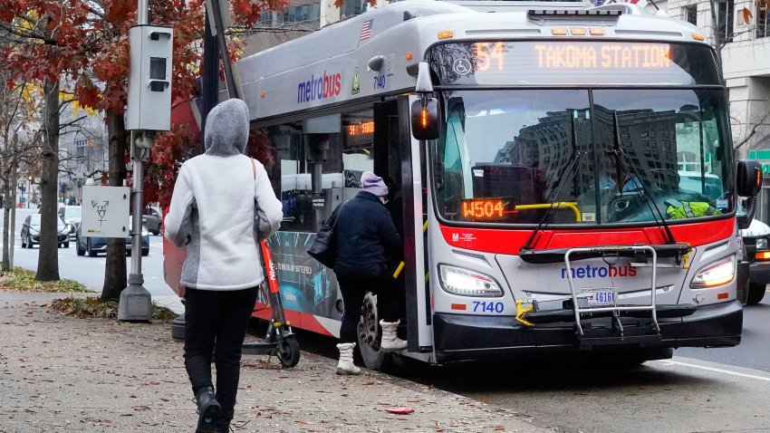 Passengers boarding a Metrobus in downtown Washington, Wednesday, Dec. 7, 2022.