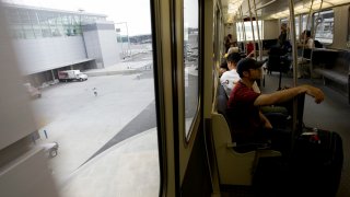 Passengers in the new AirTrain in operation at Kennedy Airport. The Air Train shuttles passengers between the airport terminals, long term parking, and the subway. It is operated by the Port Authority of New York and New Jersey. (Photo by James Leynse/Corbis via Getty Images)