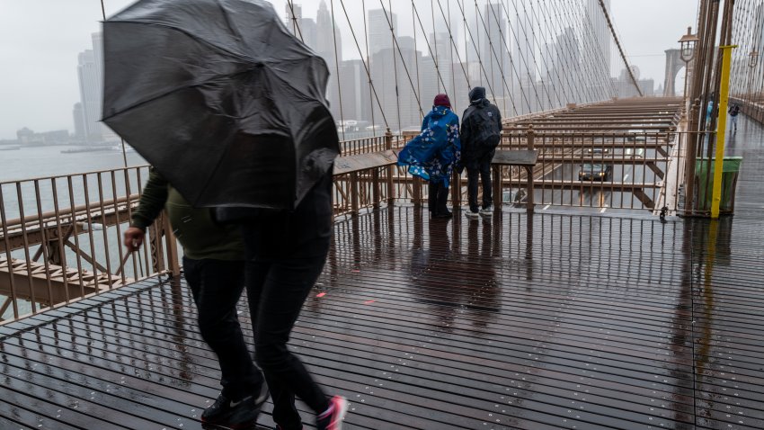 NEW YORK, NEW YORK – SEPTEMBER 25: People walk over the Brooklyn Bridge during heavy rain and high winds as the remnants of Tropical Storm Ophelia continue to move through the area on September 25, 2023 in New York City. Much of the northeast U.S. saw a weekend of heavy rain and wind as the slow moving storm lingered from the Carolinas to New York City.