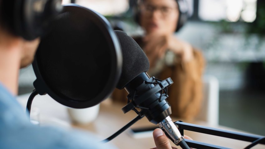 cropped view of blurred radio host talking in studio