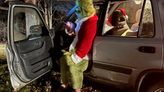 A man in a Grinch costume after crashing his car in Exeter, New Hampshire, on the night of Christmas 2023.