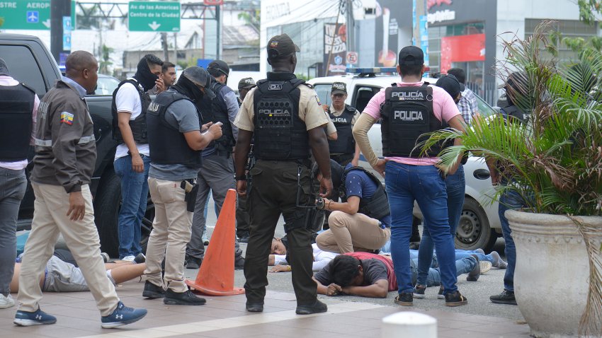 GUAYAQUIL, ECUADOR – JANUARY 9: Police officers arrest suspected terrorists after taking control of the TC Televisión on January 9, 2024 in Guayaquil, Ecuador. A group of armed and hooded men broke into TC Guayaquil during a live news transmission and held a member of the media at gunpoint as the country is currently under a state of emergency in search of most wanted criminal.  (Photo by Romina Duarte/Agencia Press South/Getty Images)