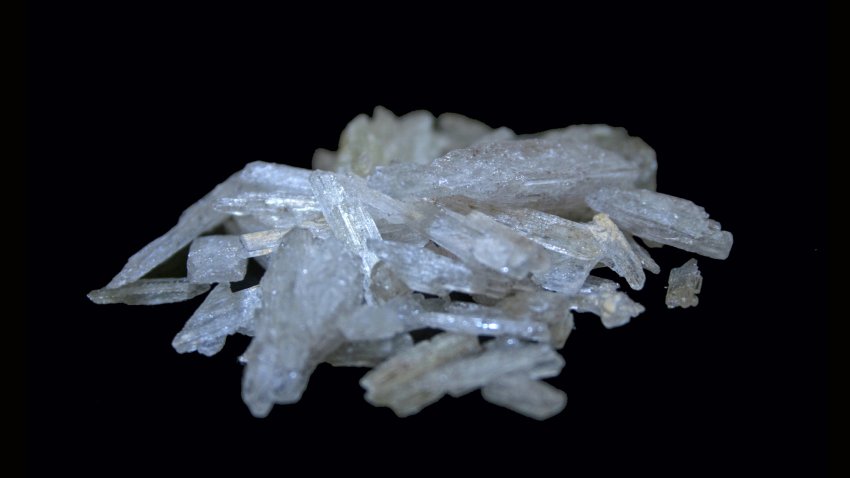 An image of a small pile of crystal methamphetamine on a black background